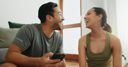 Laughing, phone and happy couple in home for funny meme, comedy or comic. Man, woman and joke with...