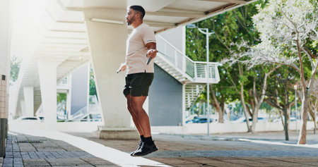 Fitness, man and skipping rope in city with exercise for warm up, physical activity and cardio...