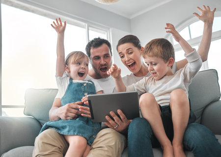 Sofa, excited and parents with children on tablet for online games, winning and celebrate. Family,...