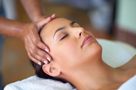 Head massage, calm and woman at spa for holistic scalp nourishment, healing or stress relief. Relax, skin therapy and hands on female person for facial therapeutic treatment at wellness salon.の写真素材