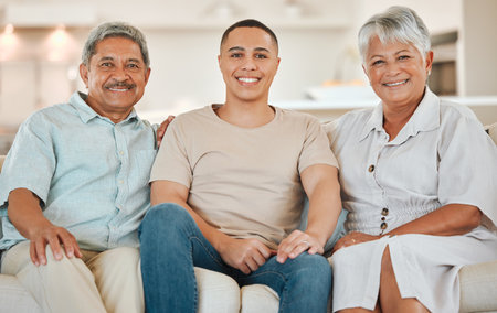 Family, portrait and senior parents with son in lounge for bonding and happy on sofa as leisure on weekend. Elderly people, child and relax with smile for visit, relationship and comfort in houseの写真素材