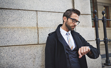 Travel, businessman and check time in city for clock, schedule and patience in morning for lift. Urban, male person or lawyer with watch for appointment, commute and waiting for taxi by mockup spaceの写真素材