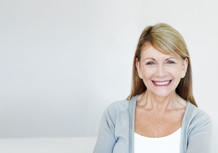 Smile, confident and portrait of senior woman in studio with mockup space for retirement. Face,...