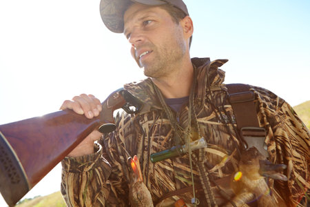Man, hunter and rifle in scouting for sport, activity and trophy as wildlife enthusiast. Male...