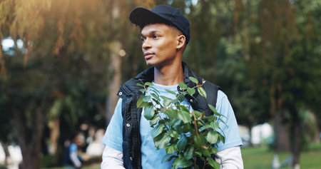 Help, volunteer and man in park with plant for growth, development or support on earth day. Green,...