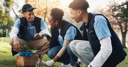 Nature, volunteer and people with plant in park for growth, sustainability and eco friendly charity outreach. Gardening, earth day and men and women with sprout for environment, ecosystem and ecologyの写真素材
