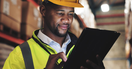 Inspection, black man or tablet in logistics for checklist, distribution or stock management. Supply chain, employee or supervisor with tech for shipping orders, quality control or warehouse at nightの写真素材