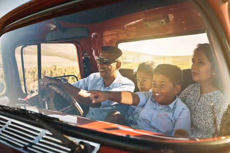 Parents, children and driving on road trip with point, smile and pickup truck for travel on...