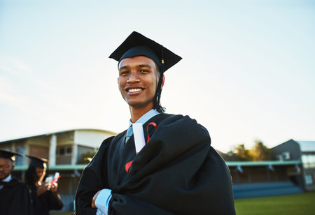 Portrait, graduate and happy man with arms crossed at university outdoor for success, milestone or...