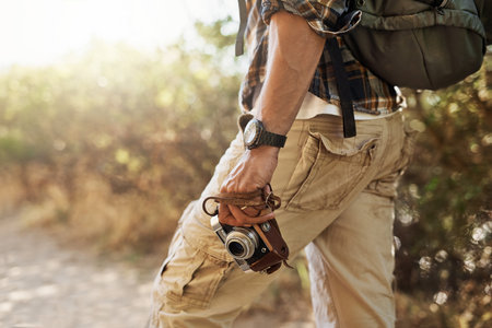 Man, hand and camera for photography in nature, outdoor hiking and travel journalist for research. Male person, lens and capture climate of Peru for earth journal, study plants and trekking touristの写真素材