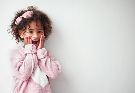 Surprise, happy and portrait of child in studio with mockup space for deal, promotion or prize. Shock, winning and girl kid from Colombia with wow, excited or omg expression by white background.の写真素材