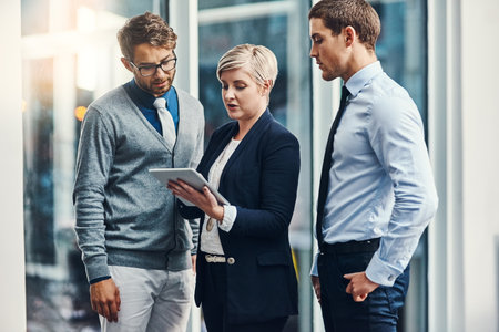 Teamwork, people and tablet for review or feedback in company as financial officer in accounting agency. Business, tablet and collaboration for growth, career as consultant in bank or insurance firmの写真素材