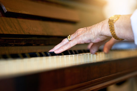 Home, hands and old woman with piano, sound or instrument with talent, music or training for performance. Closeup, classical artist or senior person with culture, audio or practice with hobby or jazzの写真素材
