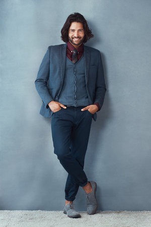 Portrait, businessman and happy for fashion in studio on gray background with hands on pocket. Male person, confidence and smile as entrepreneur with office wear, outfit and elegant style or clothesの写真素材