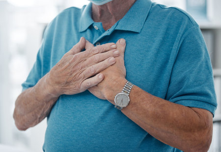 Senior man, chest and hands for heart attack, hospital and stress on lungs or anxiety emergency. Elderly male person, pain and cardiovascular stroke or asthma, cardiac arrest and disease or distressの写真素材