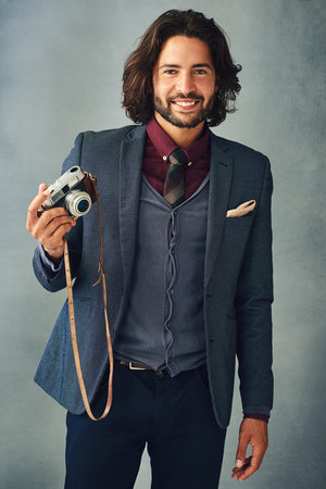 Studio, portrait and man with vintage camera for photography, artistic and creative expression with...