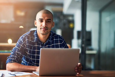 Portrait, laptop and creative business man in startup office for career or job in Brazil. Face,...