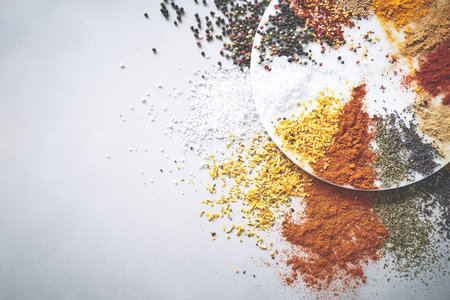 Variety, powder and spices in studio for ingredients, herbs and aroma for sensory appeal with culinary. Space, seasoning and flavor for cooking with condiment, pepper and above white backgroundの写真素材