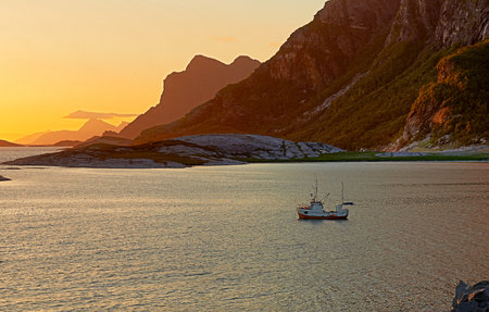 Beach, sunset or landscape of mountains with ship, natural environment or countryside in Norway. Zen water, calm peace or scenic view of Europe or ocean for outdoor travel, holiday and vacation breakの写真素材