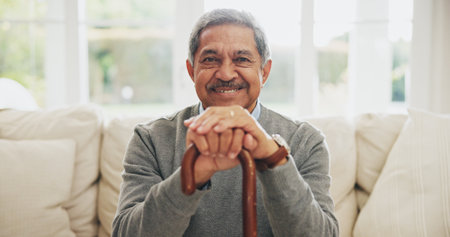 Portrait, senior man and walking stick for Arthritis in elderly care, wellness or health. Happy pensioner, person with a disability and cane for support, balance or movement in retirement home in UAEの写真素材