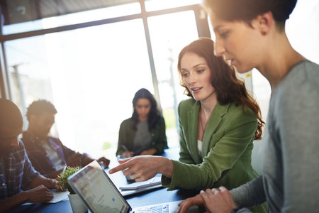 Office, mentor and business people with laptop screen for solution, discussion and access to company page. Digital, web designer and manager in creative agency for helping, startup progress or reviewの写真素材