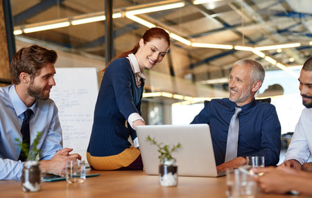Business people, smile and teamwork with laptop in meeting, planning and cooperation in office....