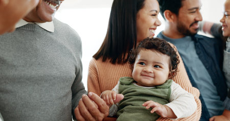 Happy family, parents and grandparents with baby for bonding, weekend or holiday at home. Mother, father and grandma or grandpa with cute toddler, kids or siblings for generations or youth at houseの写真素材