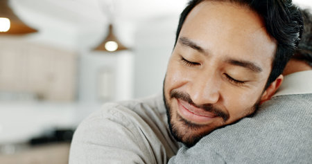 Adult son, hug and dad in house, love or comfort with happiness, relax or bonding together in lounge. Senior parent, father or embrace with compassion, support or security with weekend break or joyの写真素材