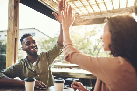 Smile, couple and high five with coffee at cafe for morning breakfast, date success and celebrate relationship. Happy, African people and beverage for love commitment, anniversary goal and restaurantの写真素材