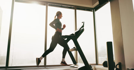 Woman, fitness and running on treadmill at gym for cardio exercise, workout and training...