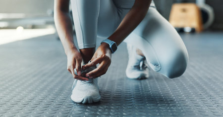 Fitness, hands and laces with person in gym, getting ready for start of training or workout....