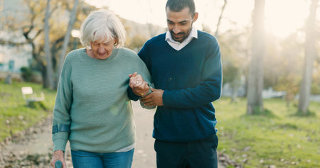 Park, walking and caregiver with senior woman for assisted living, support and care in nature....