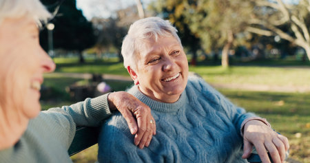 Friends, happy and senior women in park for bonding, conversation and relax together outdoors....