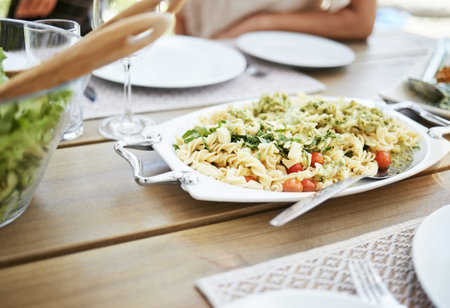 Food, dining table and salad with vegetables, utensils and party with summer event, nutrition and ingredients. Closeup, recipe and pasta for lunch, eating and organic with cuisine, dish and gourmetの写真素材