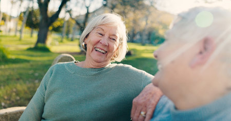 Friends, laugh and elderly women in park for bonding, conversation and relax together outdoors....