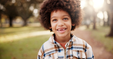 Portrait, boy and black kid in park, joy and afro with nature, playing and happiness with weekend...
