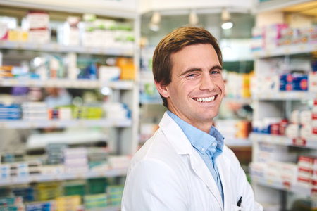 Pharmacy, medical and smile with portrait of man in store for medicine, advice and healthcare. Pills, insurance and antibiotic prescription with pharmacist for help, drugstore and dispensaryの写真素材
