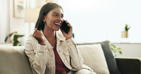 Home, phone call and woman with celebration, smile and communication with network, excited and wow. Person, apartment and girl on sofa, smartphone and cheering with positive news, winner and successの写真素材