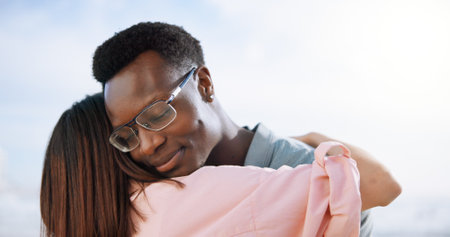 Love, hug and care with couple at beach for travel destination, summer and honeymoon vacation. Relax, tropical and adventure with man and woman on date for holiday, bonding and romance togetherの写真素材