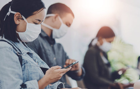 Woman, phone and mask in airport for travel, safety and reading pandemic news on internet. People,...