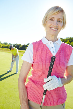 Golfing, smile and portrait of woman at country club for practice, challenge or exercise outdoor. Happy, person and mature female golfer from Ireland by cart for training, competition or tournament.の写真素材