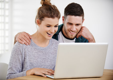 Happy, home or couple on laptop for choice, reading online article or interior design website. Smile, house rental option or people typing on technology for renovation research, mortgage and loanの写真素材