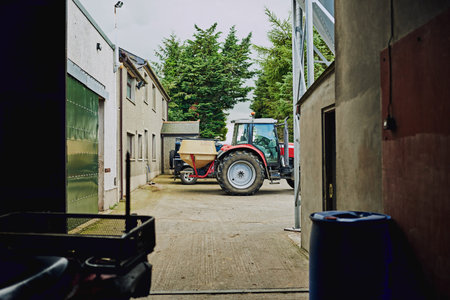 Farm, agriculture and industrial tractor at warehouse for dairy production, storage and service...