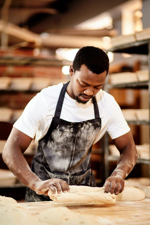Male person, work and baking bread in kitchen as small business or entrepreneur in cafe or bakery....