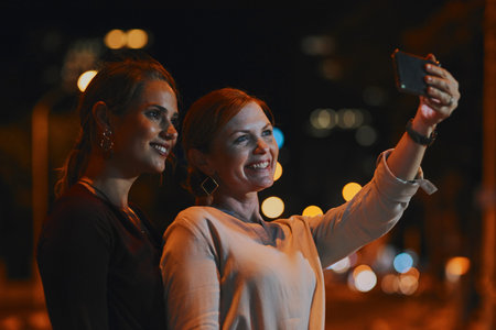 Happy woman, friends and night with selfie for photography, memory or moment together in city....