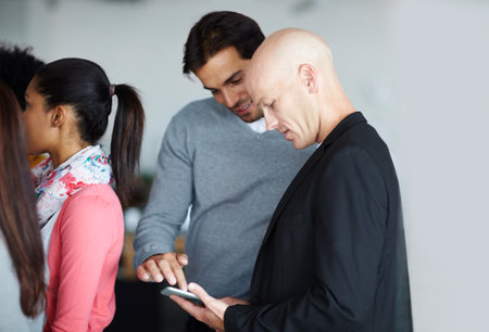Office, business people and online with tablet for meeting, research and scroll on company website. Workplace, design team and connection with digital for startup page, review and creative agencyの写真素材