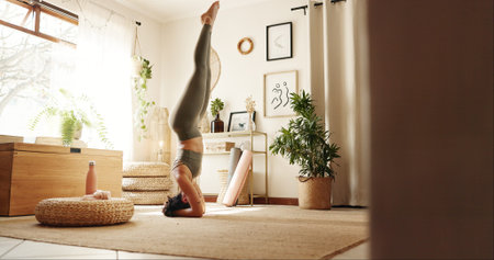 Head stand, pilates and woman in home for exercise, chakra balance or health in morning routine....
