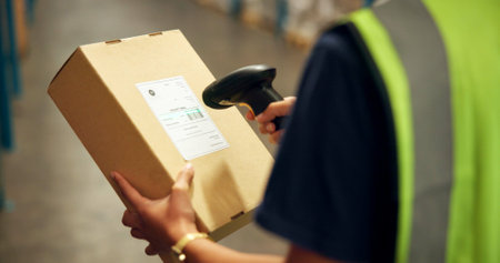 Employee, hands and box with scanner at warehouse for product, stocktaking and distribution. Manufacturing, person and barcode for delivery or package for supplier, supply chain and logisticsの写真素材