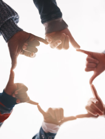 Hands, people and unity with students, group and huddle outdoor in nature for summer together. Sky, love and solidarity with shaka, gesture and friends standing in circle from below for educationの写真素材