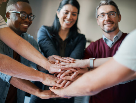 Employees, hands and pile in huddle for cooperation, teamwork and diversity in company mission. Business people, stack and circle for motivation with goals, solidarity and workforce collaborationの写真素材